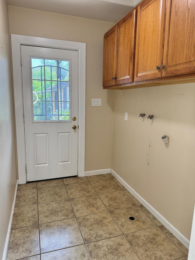1382 N Thorne Ave, Fresno, CA 93728 - laundry area featuring cabinet space, baseboards, light tile patterned flooring, and washer hookup