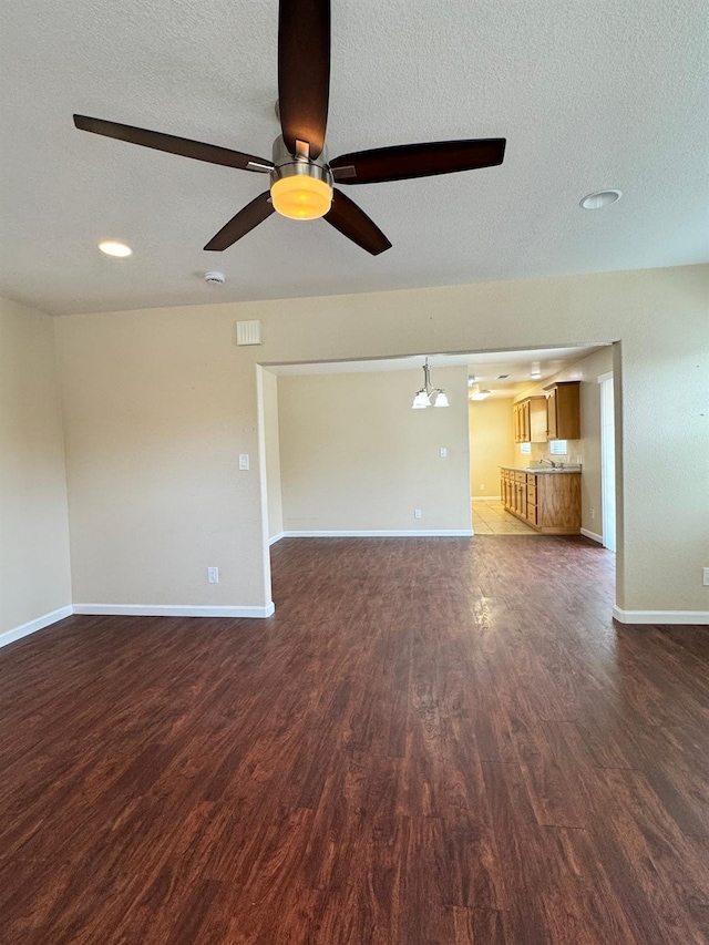 1382 N Thorne Ave, Fresno, CA 93728 - unfurnished living room featuring wood finished floors, baseboards, a ceiling fan, and a textured ceiling