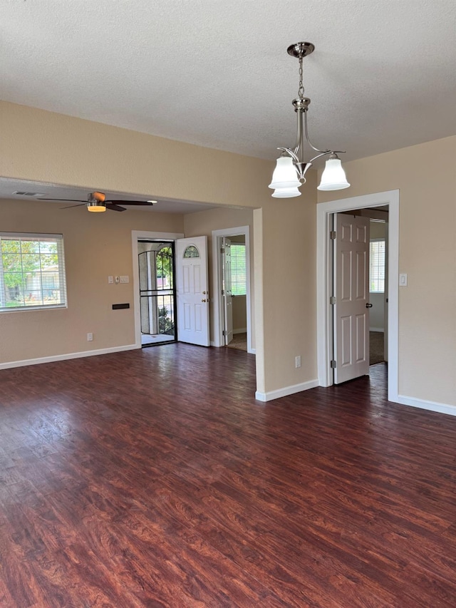 1382 N Thorne Ave, Fresno, CA 93728 - empty room with dark wood-type flooring, a chandelier, and plenty of natural light