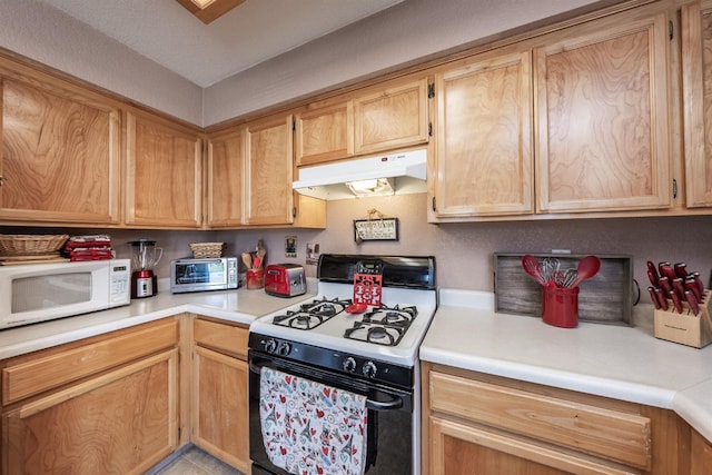 1238 La Jolla Way, Madera, CA 93638 - kitchen with gas range, white microwave, under cabinet range hood, and light countertops