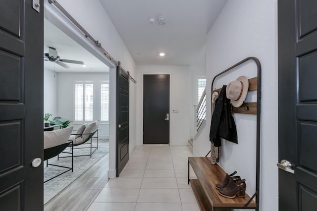 2867 E Tamarind Dr, Fresno, CA 93730 - foyer entrance featuring a barn door, plenty of natural light, stairway, ceiling fan, and recessed lighting