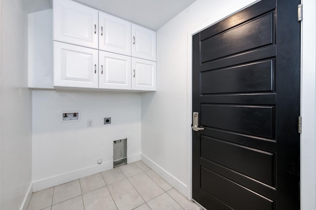 2867 E Tamarind Dr, Fresno, CA 93730 - laundry area with cabinet space, electric dryer hookup, hookup for a washing machine, baseboards, and light tile patterned floors