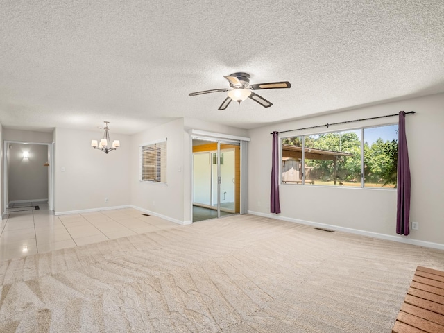 1646 W Millbrae Ave, Fresno, CA 93711 - unfurnished living room with a chandelier, a ceiling fan, carpet, baseboards, and a textured ceiling