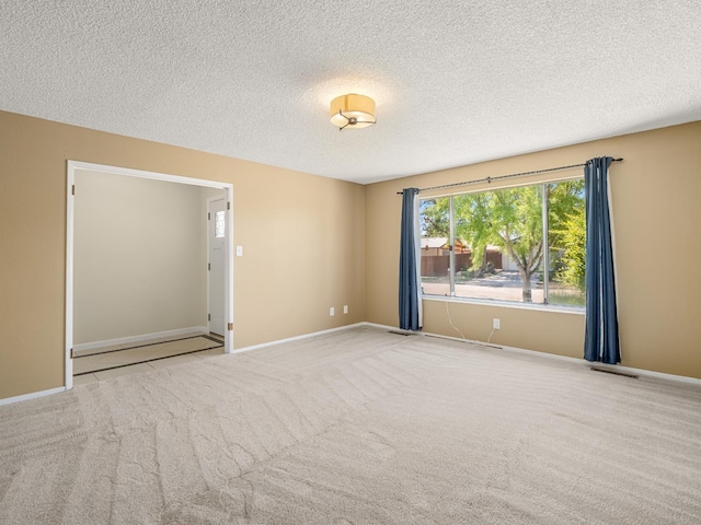 1646 W Millbrae Ave, Fresno, CA 93711 - spare room with a textured ceiling, carpet, and baseboards