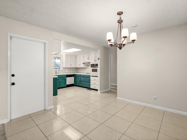 1646 W Millbrae Ave, Fresno, CA 93711 - kitchen with white appliances, light countertops, light tile patterned floors, tasteful backsplash, and a textured ceiling