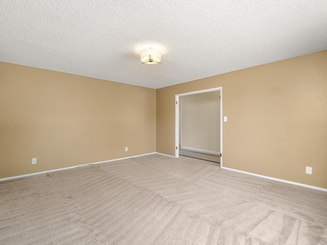 1646 W Millbrae Ave, Fresno, CA 93711 - spare room featuring a baseboard radiator, light carpet, a textured ceiling, and baseboards