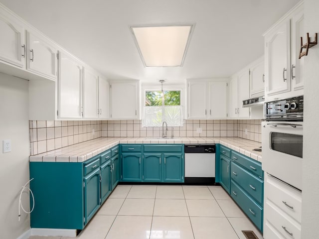1646 W Millbrae Ave, Fresno, CA 93711 - kitchen with white appliances, a sink, white cabinets, and backsplash