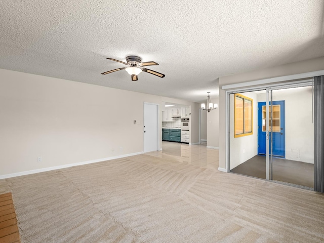 1646 W Millbrae Ave, Fresno, CA 93711 - unfurnished living room featuring ceiling fan, a chandelier, baseboards, light colored carpet, and a textured ceiling