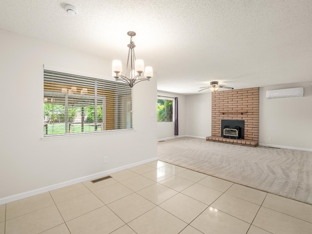 1646 W Millbrae Ave, Fresno, CA 93711 - unfurnished living room with a wall mounted AC, ceiling fan, a textured ceiling, a fireplace, and baseboards