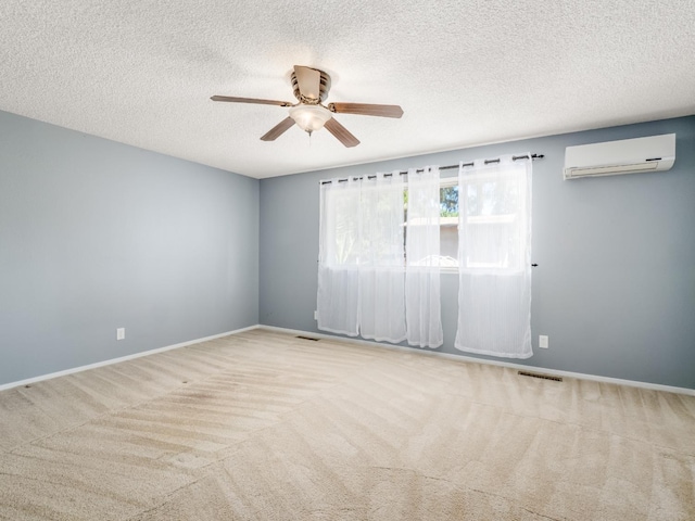 1646 W Millbrae Ave, Fresno, CA 93711 - carpeted empty room with an AC wall unit, a ceiling fan, a textured ceiling, and baseboards