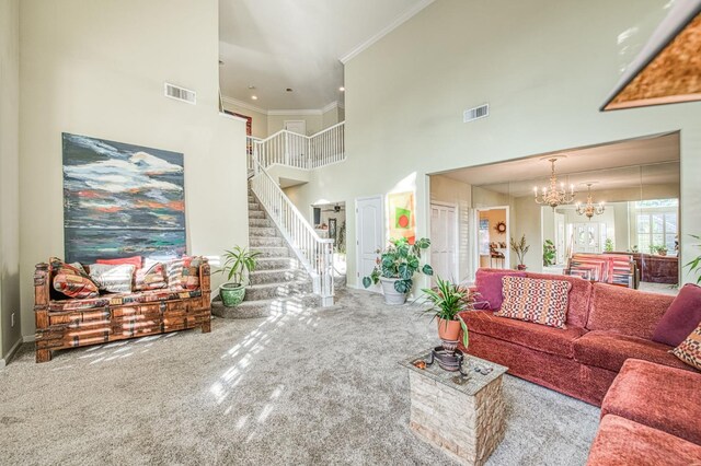 2895 W Kensington Ln, Fresno, CA 93711 - living room featuring a high ceiling, carpet, ornamental molding, stairs, and a chandelier