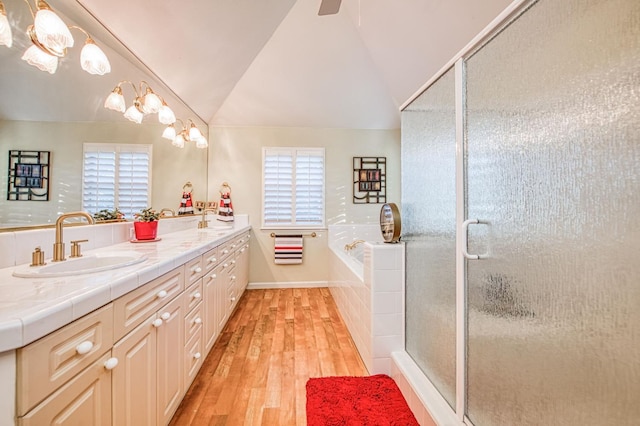 2895 W Kensington Ln, Fresno, CA 93711 - bathroom featuring hardwood / wood-style floors, double vanity, plenty of natural light, a bath, and lofted ceiling