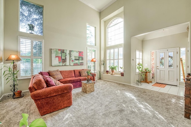 2895 W Kensington Ln, Fresno, CA 93711 - tiled living room featuring a towering ceiling, carpet floors, crown molding, and baseboards