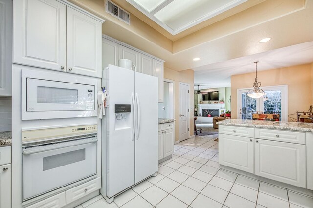 2895 W Kensington Ln, Fresno, CA 93711 - kitchen featuring white appliances, white cabinets, light tile patterned floors, hanging light fixtures, and ceiling fan