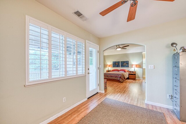 2895 W Kensington Ln, Fresno, CA 93711 - bedroom with arched walkways, wood finished floors, baseboards, and ceiling fan