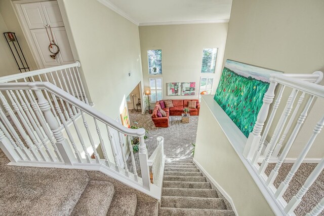 2895 W Kensington Ln, Fresno, CA 93711 - stairway featuring carpet flooring, a high ceiling, and ornamental molding