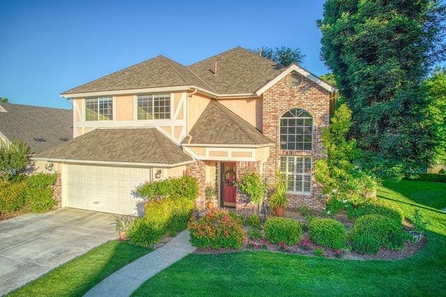 2895 W Kensington Ln, Fresno, CA 93711 - traditional-style house with a front yard, driveway, stucco siding, brick siding, and roof with shingles