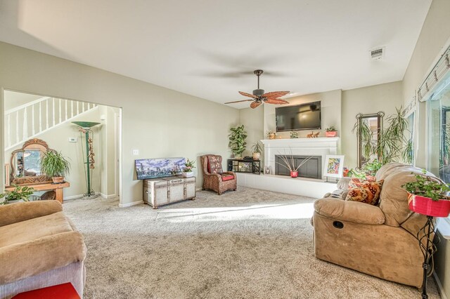2895 W Kensington Ln, Fresno, CA 93711 - carpeted living area featuring ceiling fan, a fireplace with raised hearth, and baseboards