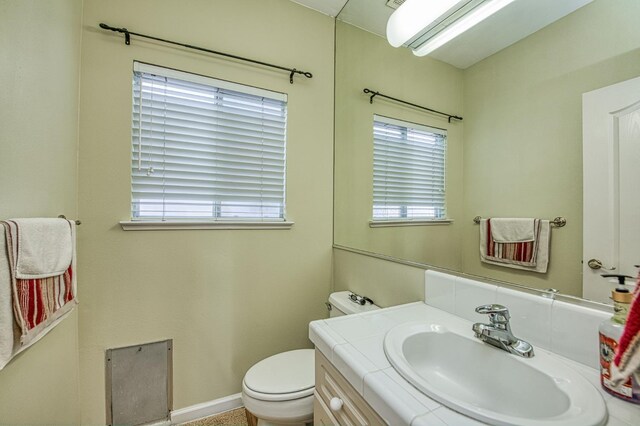 2895 W Kensington Ln, Fresno, CA 93711 - bathroom featuring vanity, toilet, and baseboards