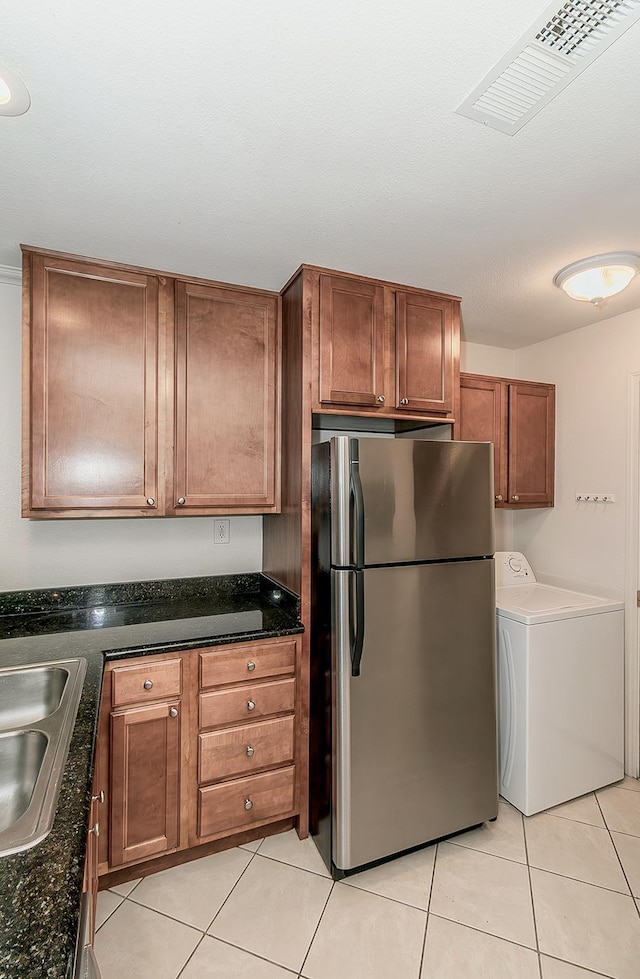7178 N Fruit Ave Unit 115, Fresno, CA 93711 - kitchen with freestanding refrigerator, washer / dryer, a sink, and light tile patterned floors