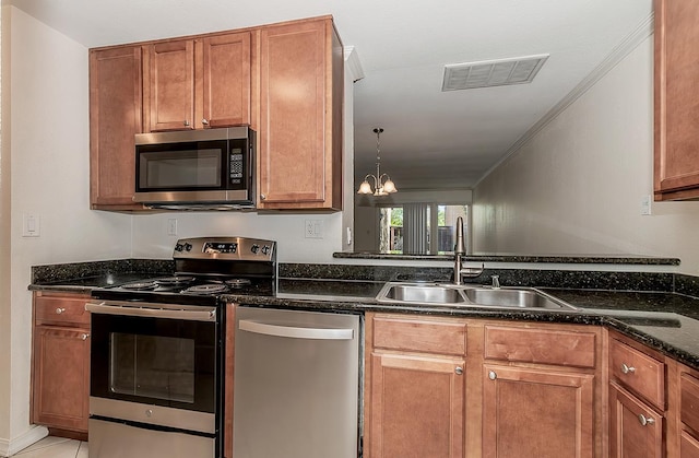 7178 N Fruit Ave Unit 115, Fresno, CA 93711 - kitchen featuring appliances with stainless steel finishes, a sink, dark stone counters, brown cabinets, and a chandelier