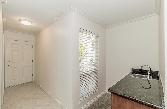 7178 N Fruit Ave Unit 115, Fresno, CA 93711 - hall featuring a sink, ornamental molding, baseboards, and light tile patterned flooring
