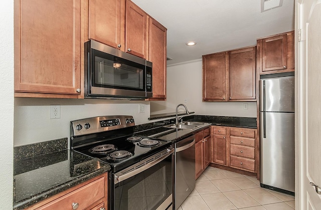 7178 N Fruit Ave Unit 115, Fresno, CA 93711 - kitchen with stainless steel appliances, a sink, light tile patterned floors, dark stone countertops, and recessed lighting