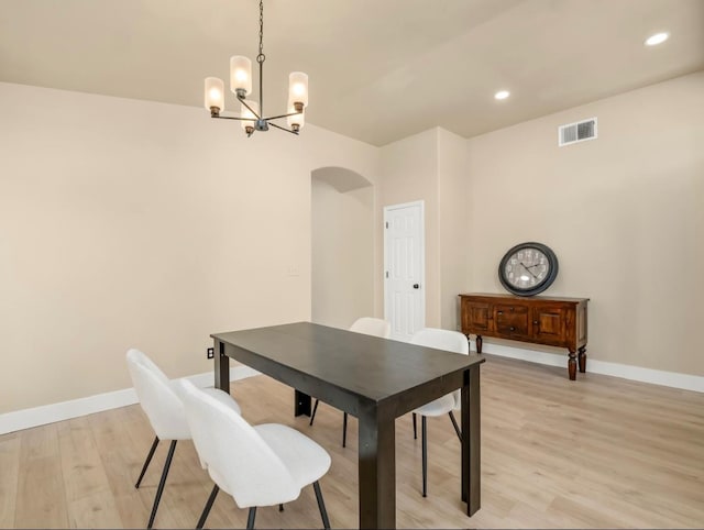 1656 N Cecelia Ave, Fresno, CA 93722 - dining room with arched walkways, light wood finished floors, a chandelier, baseboards, and recessed lighting