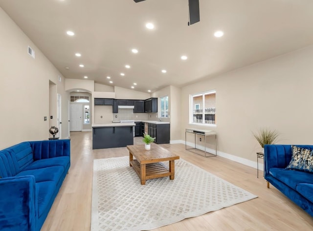 1656 N Cecelia Ave, Fresno, CA 93722 - living room featuring arched walkways, light wood-style flooring, recessed lighting, lofted ceiling, and ceiling fan