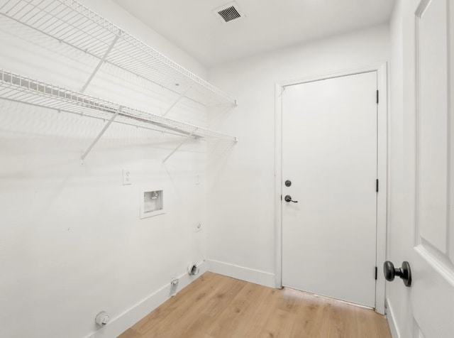 1656 N Cecelia Ave, Fresno, CA 93722 - laundry room with gas dryer hookup, washer hookup, light wood finished floors, and baseboards
