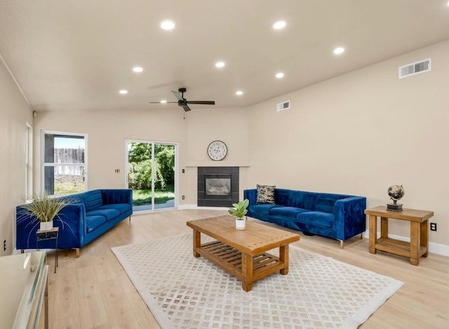 1656 N Cecelia Ave, Fresno, CA 93722 - living room featuring a ceiling fan, light wood finished floors, recessed lighting, a tile fireplace, and baseboards