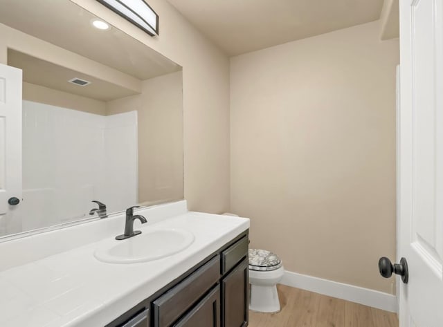 1656 N Cecelia Ave, Fresno, CA 93722 - full bathroom with toilet, vanity, wood finished floors, and baseboards