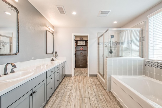 4148 Beverly Ave, Clovis, CA 93619 - full bath featuring a stall shower, a garden tub, double vanity, recessed lighting, and wood finished floors