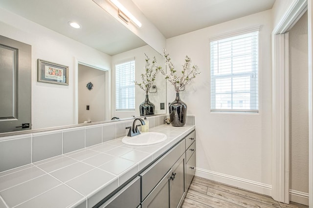 4148 Beverly Ave, Clovis, CA 93619 - bathroom with vanity, healthy amount of natural light, baseboards, and wood finished floors