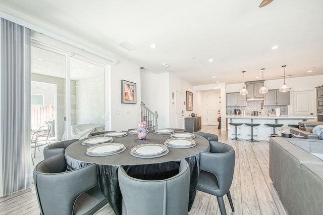 4148 Beverly Ave, Clovis, CA 93619 - dining space with light wood finished floors, stairs, and recessed lighting