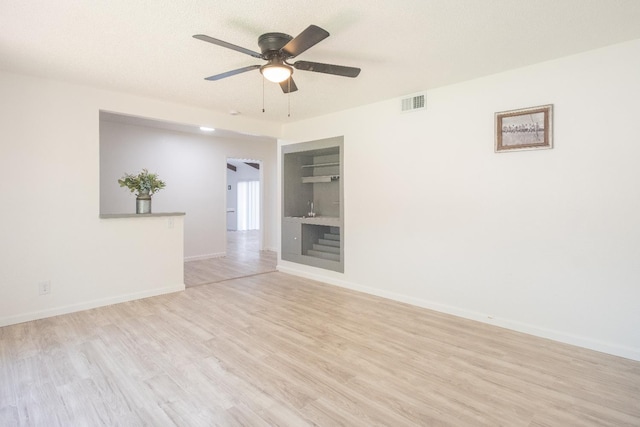 1617 W Indianapolis Ave, Fresno, CA 93705 - unfurnished room with light wood-style flooring, a ceiling fan, baseboards, and built in features