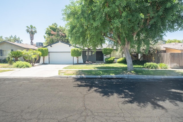 1617 W Indianapolis Ave, Fresno, CA 93705 - view of front of property featuring driveway, a garage, and stucco siding