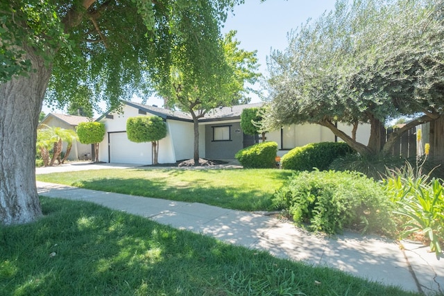 1617 W Indianapolis Ave, Fresno, CA 93705 - view of front of property featuring a garage, a front lawn, stucco siding, and concrete driveway