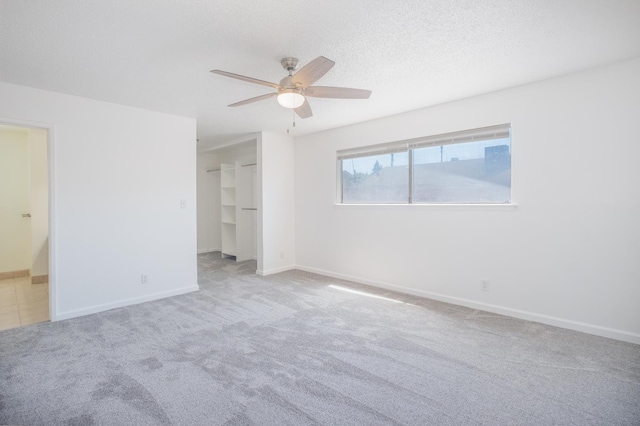 1617 W Indianapolis Ave, Fresno, CA 93705 - unfurnished bedroom with carpet, connected bathroom, baseboards, ceiling fan, and a walk in closet
