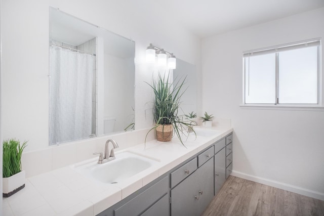 1617 W Indianapolis Ave, Fresno, CA 93705 - bathroom with vanity, wood finished floors, and baseboards