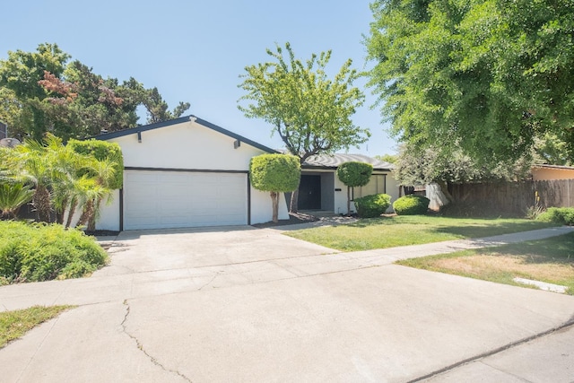 1617 W Indianapolis Ave, Fresno, CA 93705 - single story home with a garage, driveway, and stucco siding