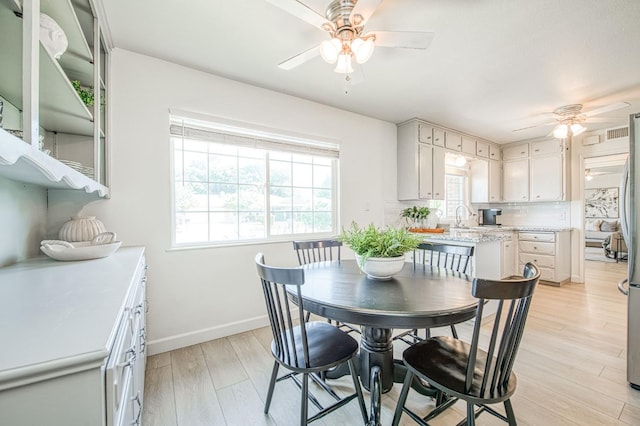 926 E Birch Ave, Fresno, CA 93720 - dining space with a ceiling fan, light wood finished floors, and baseboards