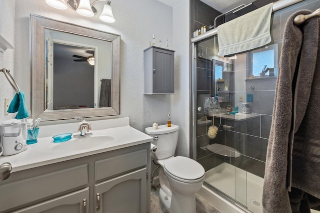 2141 Akers St, Visalia, CA 93277 - full bath with toilet, a stall shower, a textured wall, vanity, and ceiling fan