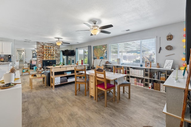 2141 Akers St, Visalia, CA 93277 - dining room featuring a ceiling fan, light wood finished floors, and a textured ceiling