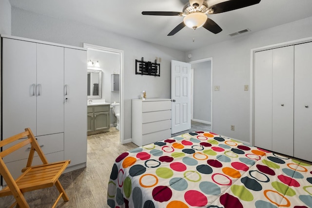 2141 Akers St, Visalia, CA 93277 - bedroom with light wood-style flooring, a closet, ensuite bath, a sink, and a ceiling fan