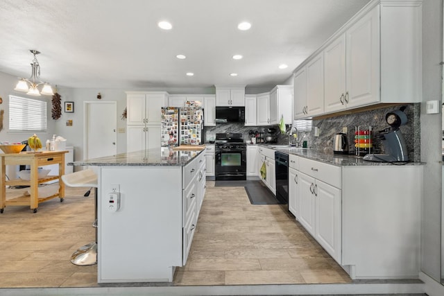 2141 Akers St, Visalia, CA 93277 - kitchen with black appliances, a sink, light wood-style floors, white cabinetry, and decorative backsplash