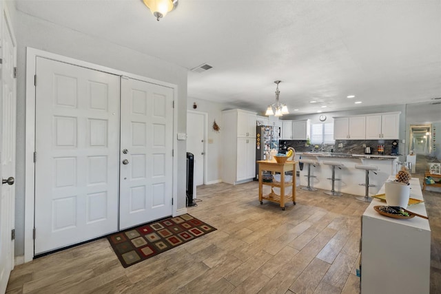 2141 Akers St, Visalia, CA 93277 - foyer entrance featuring light wood finished floors, a chandelier, recessed lighting, and baseboards