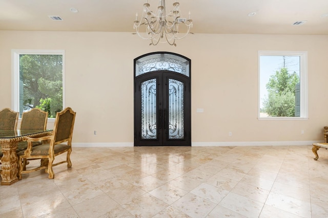 14215 Killarney Dr, Madera, CA 93636 - entrance foyer with french doors, a chandelier, healthy amount of natural light, and baseboards