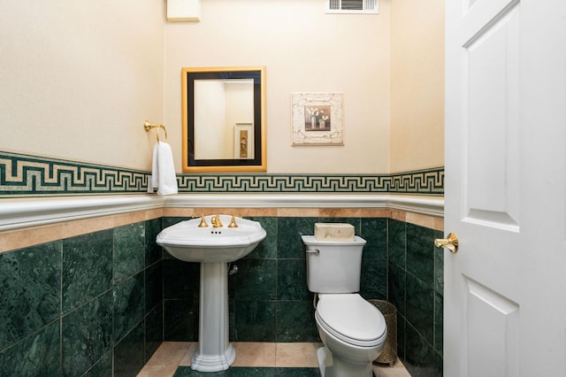 14215 Killarney Dr, Madera, CA 93636 - half bathroom with a wainscoted wall, toilet, tile walls, and tile patterned floors