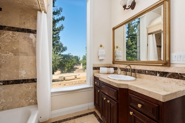 14215 Killarney Dr, Madera, CA 93636 - bathroom with vanity, healthy amount of natural light, inlaid floor details, and baseboards